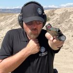 when firing a handgun how far from the body