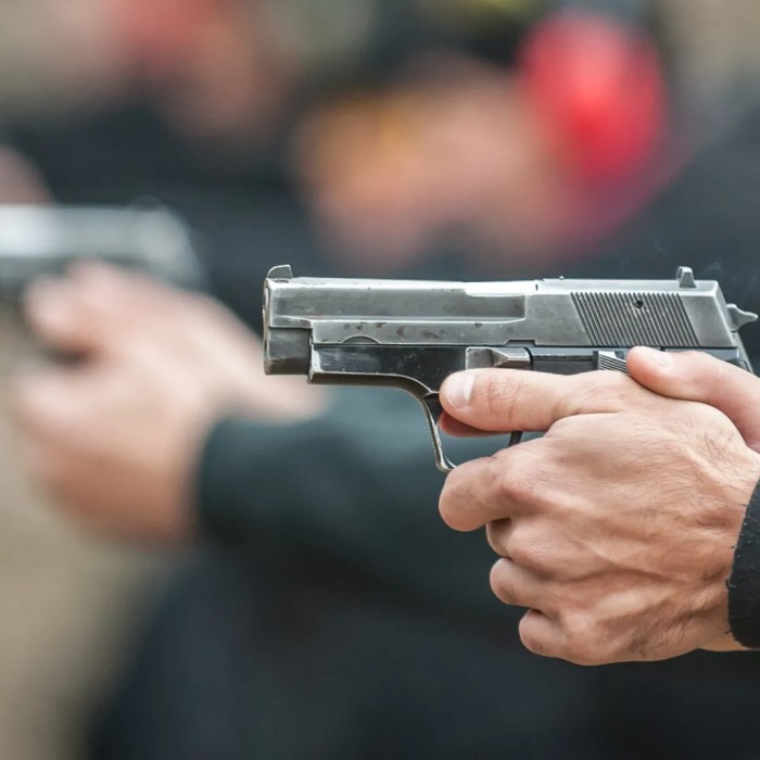 when firing a handgun how far from the body