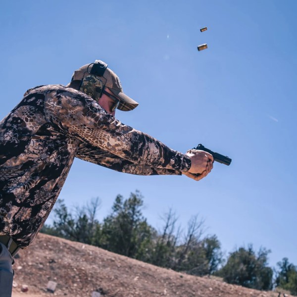 when firing a handgun how far from the body