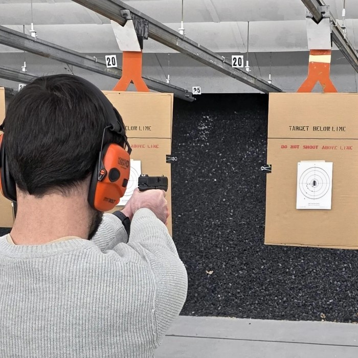 when firing a handgun how far from the body